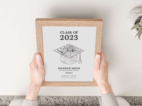 A black and white map print in the shape of a graduation cap with a pin on the university. example of text reads class of 2023, hannah davies, BEng Mechanical Engineering, graduated 18.09.2023 University of Brighton